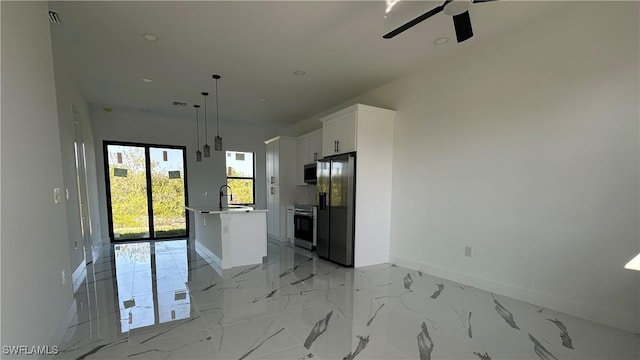 kitchen with fridge with ice dispenser, marble finish floor, a sink, white cabinetry, and baseboards