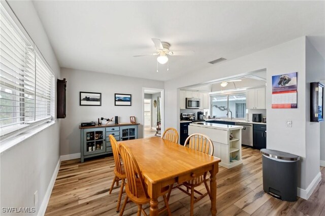 2084 Coral Point Dr, Cape Coral, FL 33990 - dining room featuring light wood finished floors, baseboards, a ceiling fan, and visible vents