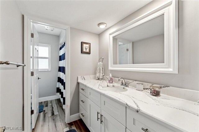 2084 Coral Point Dr, Cape Coral, FL 33990 - full bath featuring vanity, baseboards, and wood finished floors
