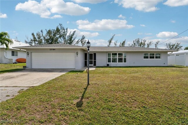 2084 Coral Point Dr, Cape Coral, FL 33990 - single story home featuring a front yard, driveway, stucco siding, and an attached garage