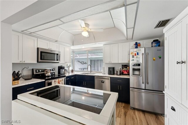 2084 Coral Point Dr, Cape Coral, FL 33990 - kitchen with a sink, visible vents, white cabinetry, and stainless steel appliances