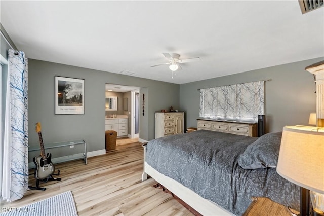 2084 Coral Point Dr, Cape Coral, FL 33990 - bedroom with visible vents, baseboards, connected bathroom, and wood finished floors