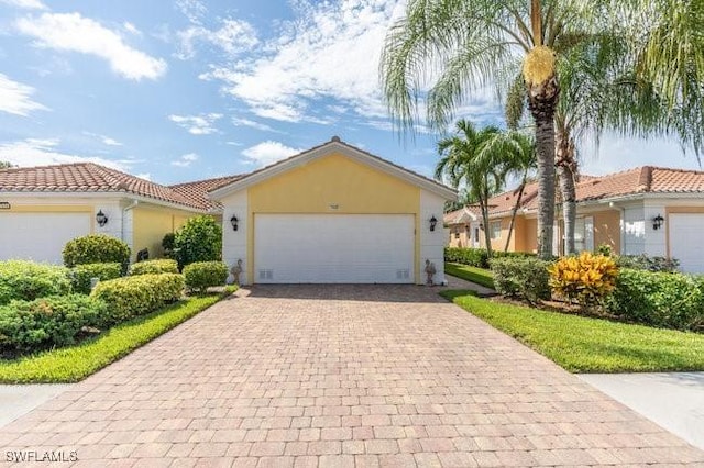 view of front of home featuring a garage, decorative driveway, and stucco siding