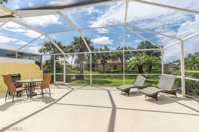 view of patio featuring a lanai