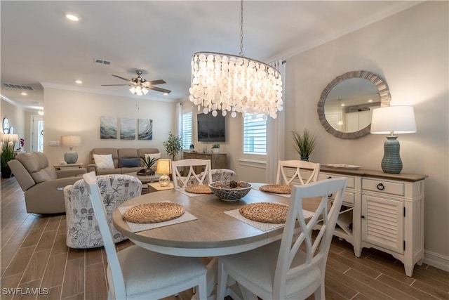 dining room with ornamental molding and ceiling fan with notable chandelier