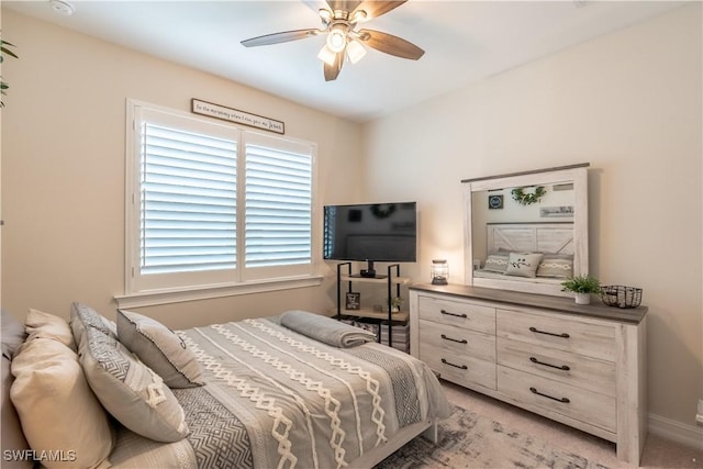 bedroom featuring ceiling fan and light colored carpet