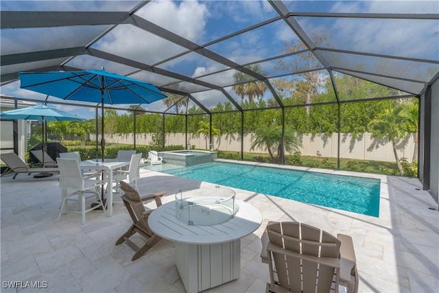 view of pool with glass enclosure, a patio area, and an in ground hot tub