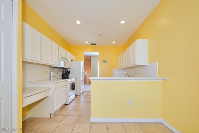 kitchen featuring kitchen peninsula, white appliances, white cabinets, and light tile patterned flooring