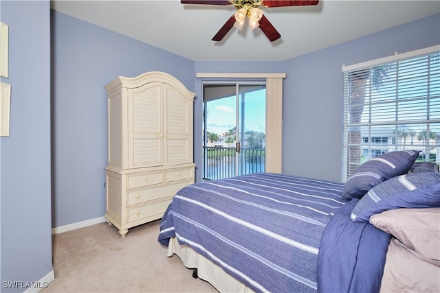 carpeted bedroom featuring access to outside and ceiling fan