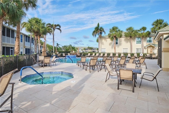 view of pool featuring a patio and a community hot tub