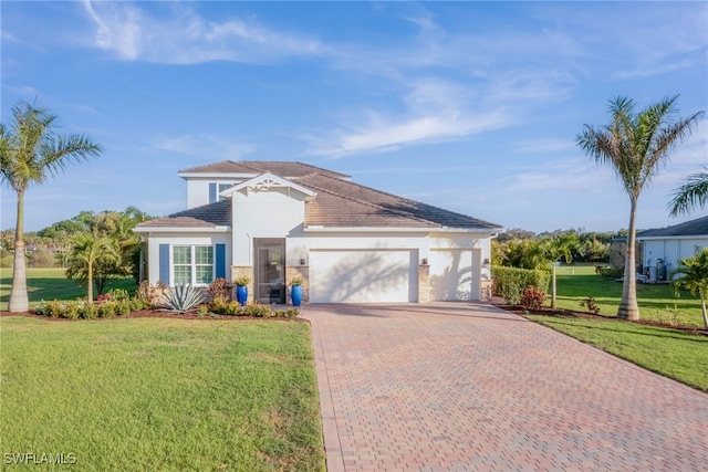 view of front facade featuring a garage, decorative driveway, a front lawn, and stucco siding