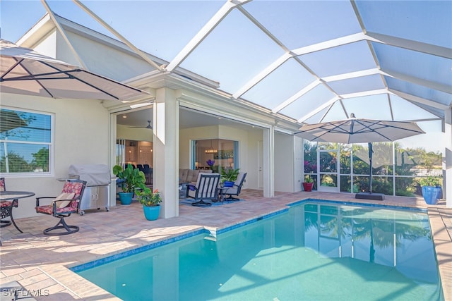 outdoor pool featuring a lanai, a grill, a patio, and ceiling fan