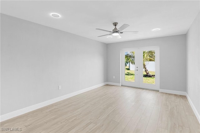 empty room featuring ceiling fan, light hardwood / wood-style floors, and french doors