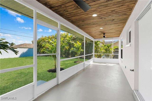 unfurnished sunroom with a ceiling fan