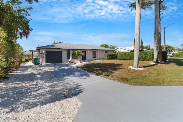 ranch-style home featuring a garage and a front yard