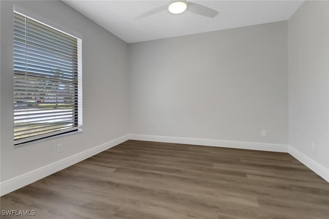 spare room with ceiling fan and dark hardwood / wood-style flooring