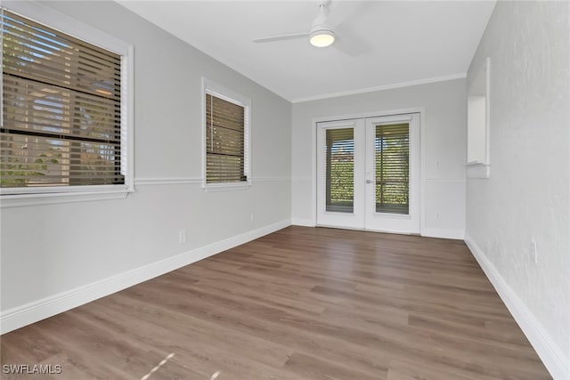 spare room featuring hardwood / wood-style flooring, ornamental molding, french doors, and ceiling fan