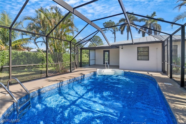 view of pool with a patio and glass enclosure