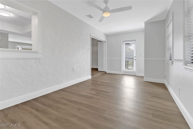 spare room with dark hardwood / wood-style floors and ceiling fan