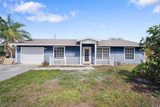 ranch-style home with a garage, a front yard, concrete driveway, and covered porch