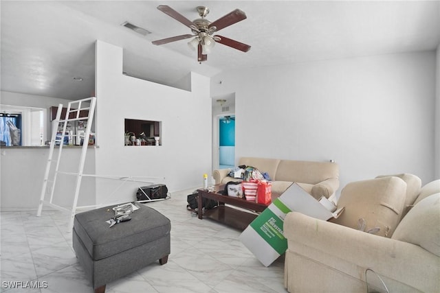 living area with lofted ceiling, marble finish floor, visible vents, and ceiling fan