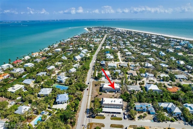 drone / aerial view featuring a water view and a beach view