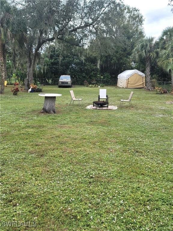 view of yard with a fire pit