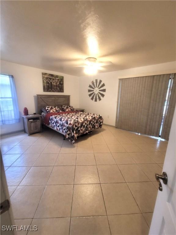 bedroom with light tile patterned floors and ceiling fan