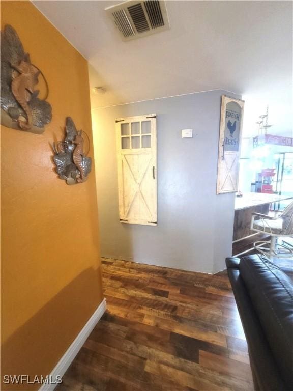 hallway with dark hardwood / wood-style flooring