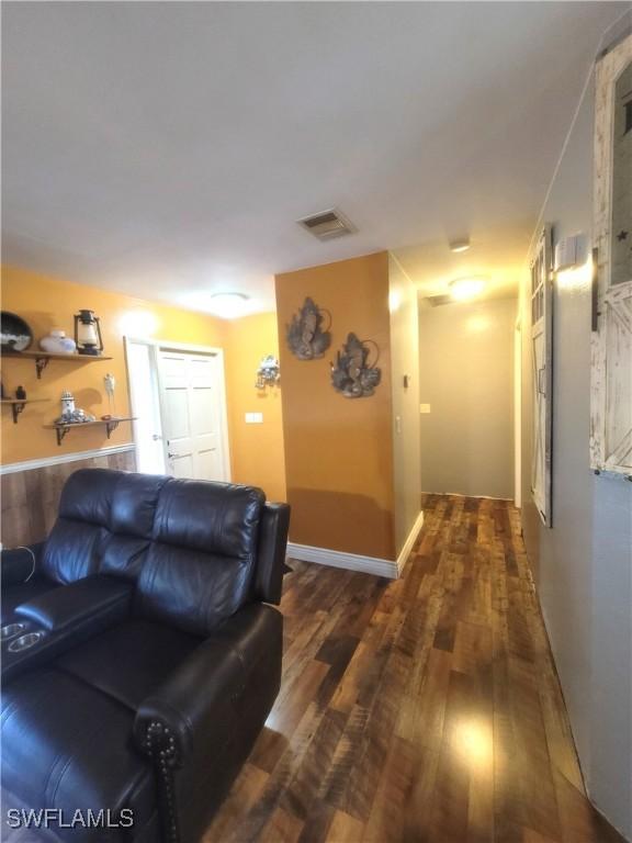 living room featuring dark wood-type flooring