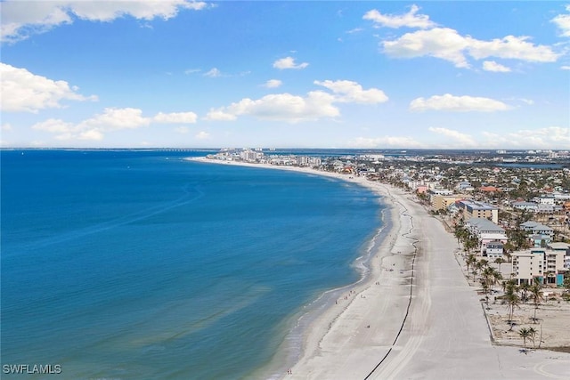 drone / aerial view with a water view and a beach view