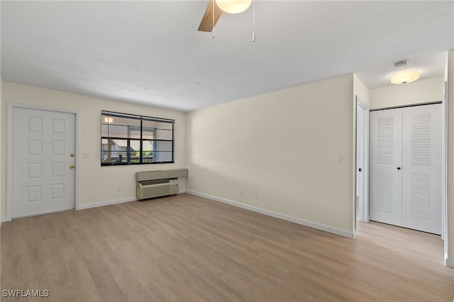 unfurnished living room featuring light hardwood / wood-style flooring and ceiling fan