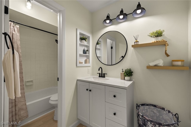 full bathroom featuring shower / bathtub combination with curtain, vanity, hardwood / wood-style flooring, and toilet