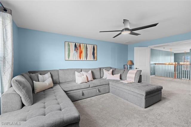 living room with carpet floors and a ceiling fan