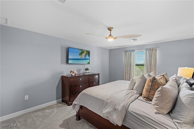 bedroom featuring light carpet, ceiling fan, visible vents, and baseboards