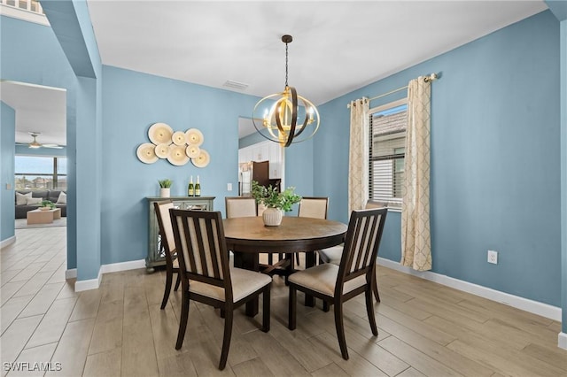 dining room featuring visible vents, light wood-style flooring, and baseboards