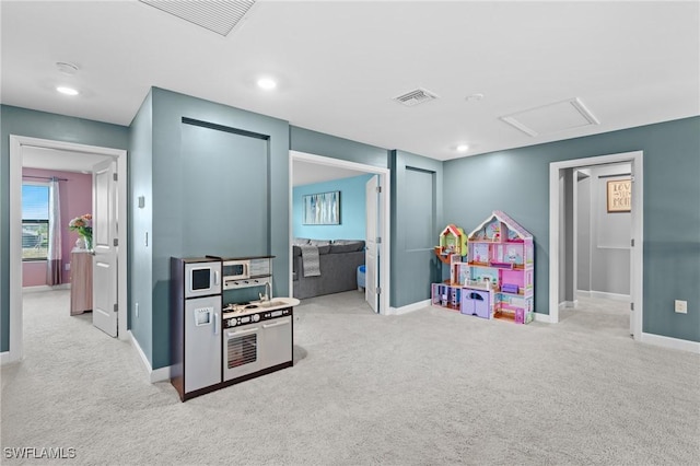 rec room featuring visible vents, carpet, attic access, and baseboards