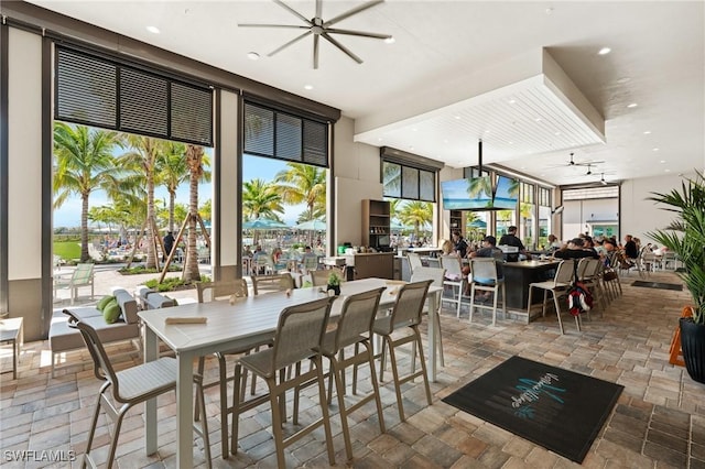 dining space with recessed lighting, stone tile flooring, and floor to ceiling windows