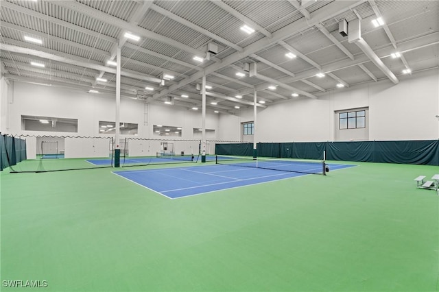 view of tennis court featuring fence