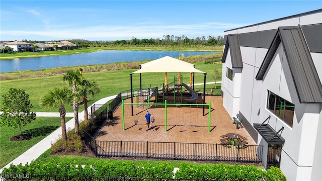 community jungle gym with a lawn and a water view