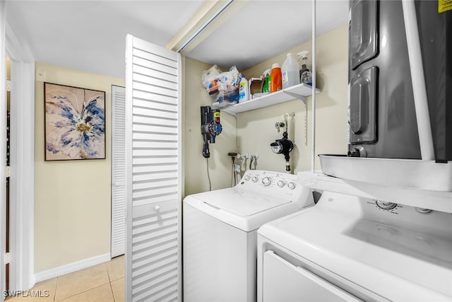 laundry area featuring washer and dryer and light tile patterned flooring