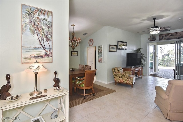 tiled living room with ceiling fan with notable chandelier