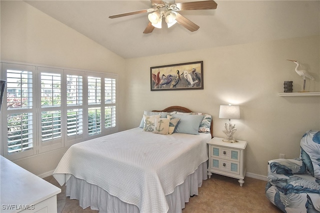 bedroom with lofted ceiling, ceiling fan, and light tile patterned floors