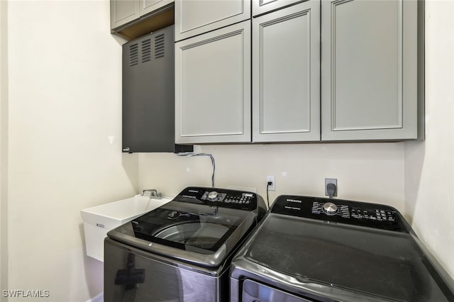 laundry room featuring cabinet space and washing machine and dryer