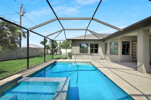 view of pool with a pool with connected hot tub, glass enclosure, a patio, and a fenced backyard