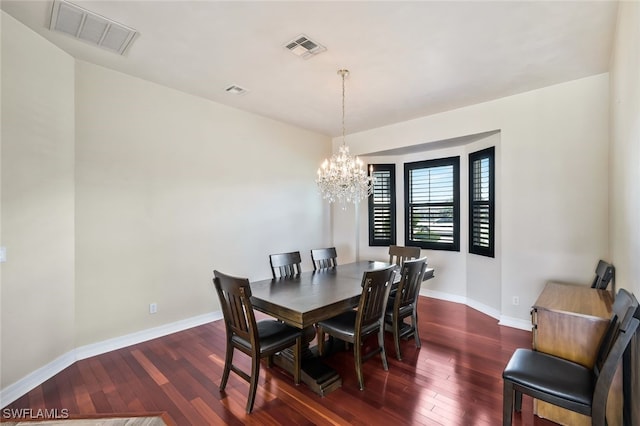 dining room featuring baseboards, visible vents, and dark wood-style flooring