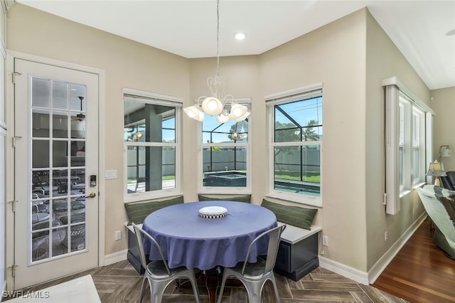 dining room featuring a chandelier, recessed lighting, and baseboards