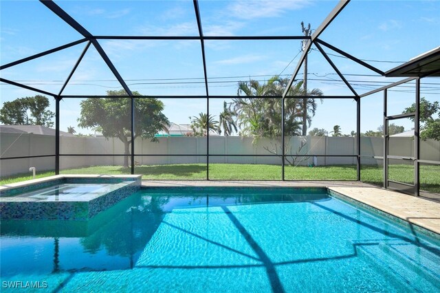 view of pool with a pool with connected hot tub, a lanai, a fenced backyard, and a yard