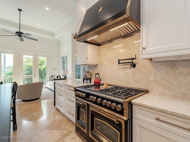 kitchen with extractor fan, white cabinetry, double oven range, decorative backsplash, and crown molding