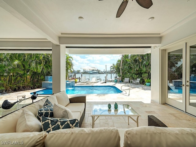 view of swimming pool featuring ceiling fan, outdoor lounge area, french doors, a fenced in pool, and a patio area